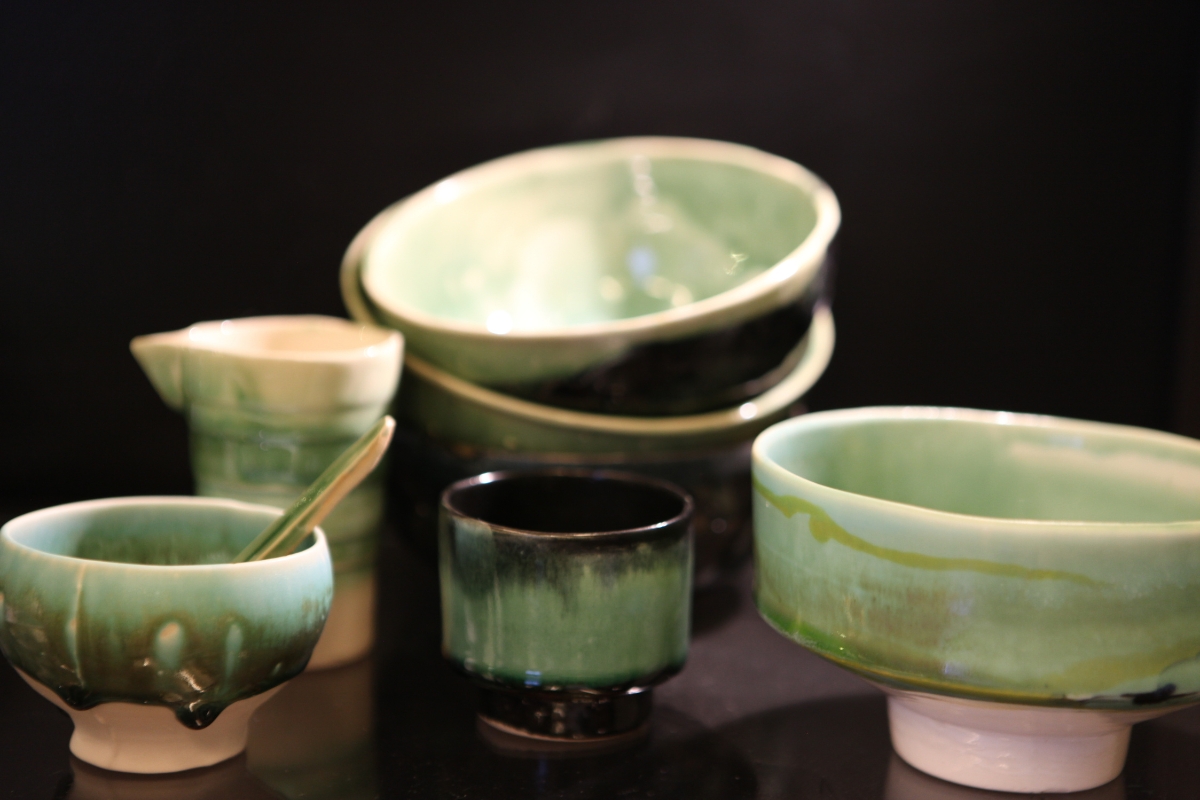 Handmade ceramic bowls, pitcher and cups with green and black glazes at Stilkar in Reykjavík
