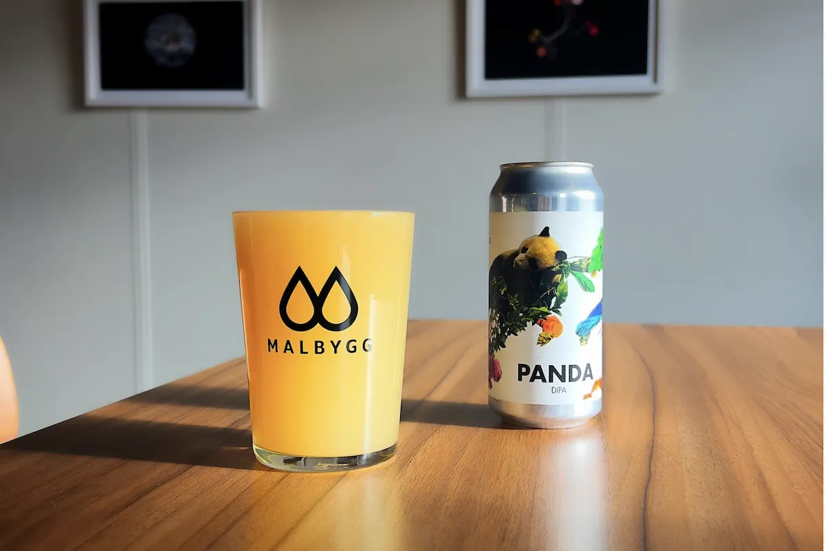 Icelandic craft beer at Malbygg Bar with a hazy Panda DIPA and signature brewery glassware, recommended by Handpicked Iceland.