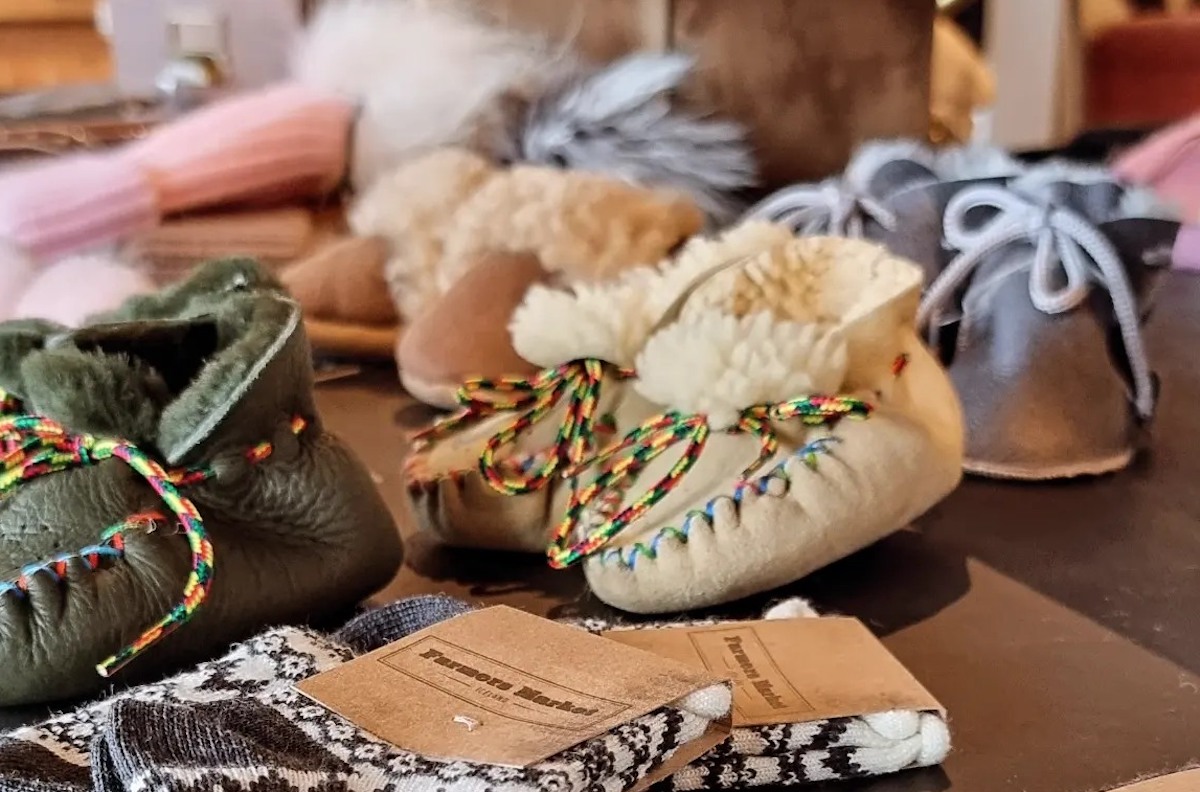 Traditional sheepskin baby shoes and wool socks at Blóðberg Seyðisfirði shop.