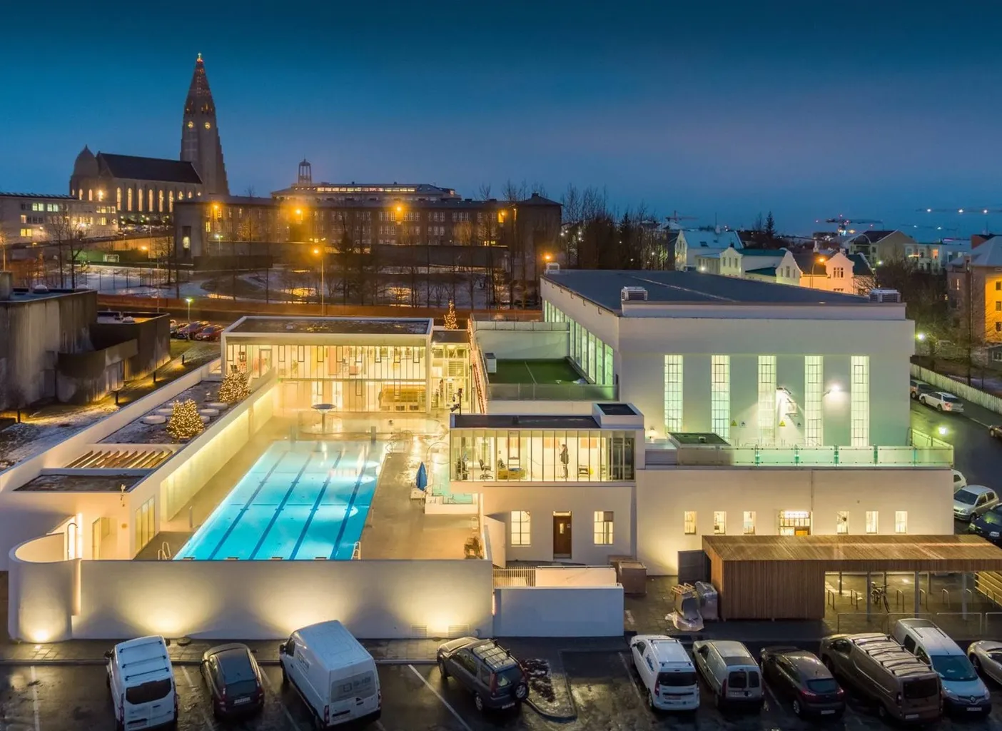 Evening at Sundhöll Reykjavik outdoor geothermal pool with city views near Hallgrimskirkja Church.