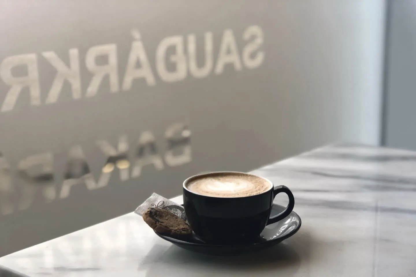 A black cup of latte served at Sauðárkróks Bakery in Sauðárkrókur.