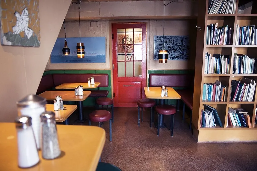 The cozy, book-filled interior of Grái Kötturinn cafe in Reykjavik.