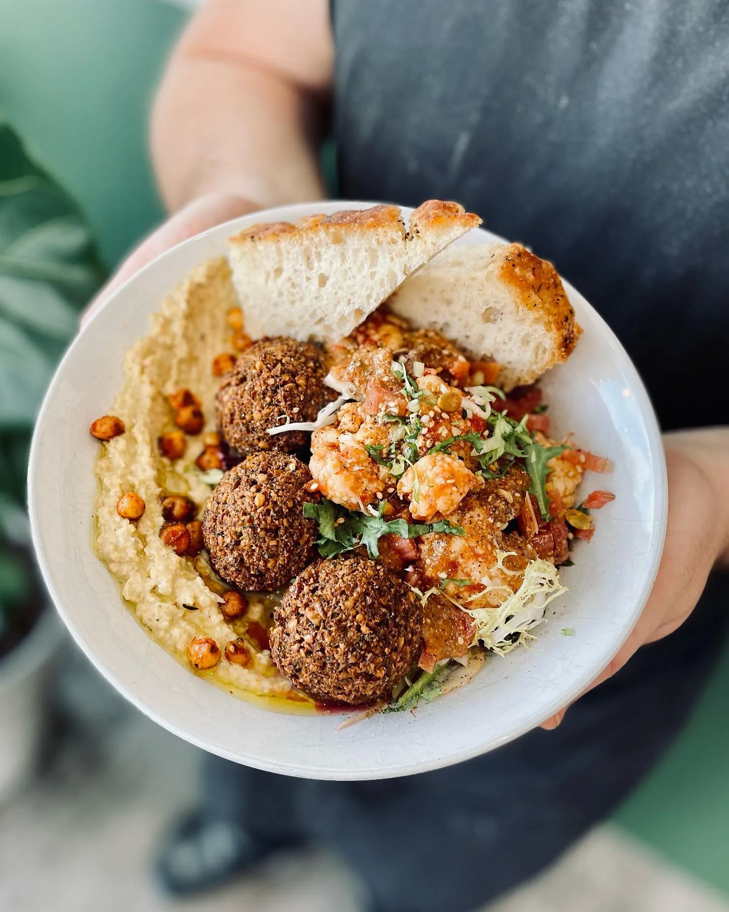 Signature falafel and hummus bowl with fresh local ingredients at Chickpea Reykjavik.