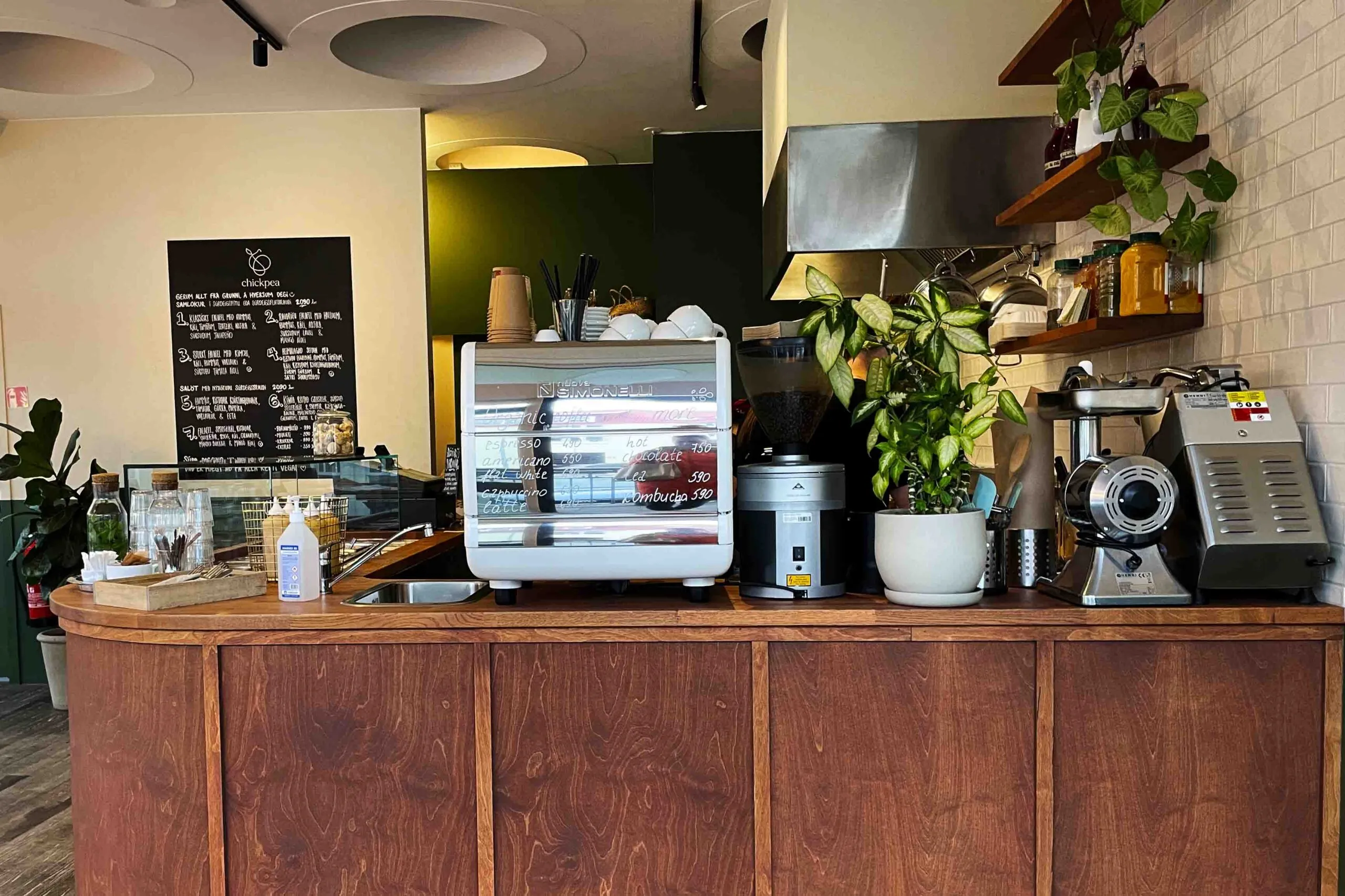 Welcoming wooden counter and menu board inside Chickpea, a family-owned vegetarian eatery in downtown Reykjavik.