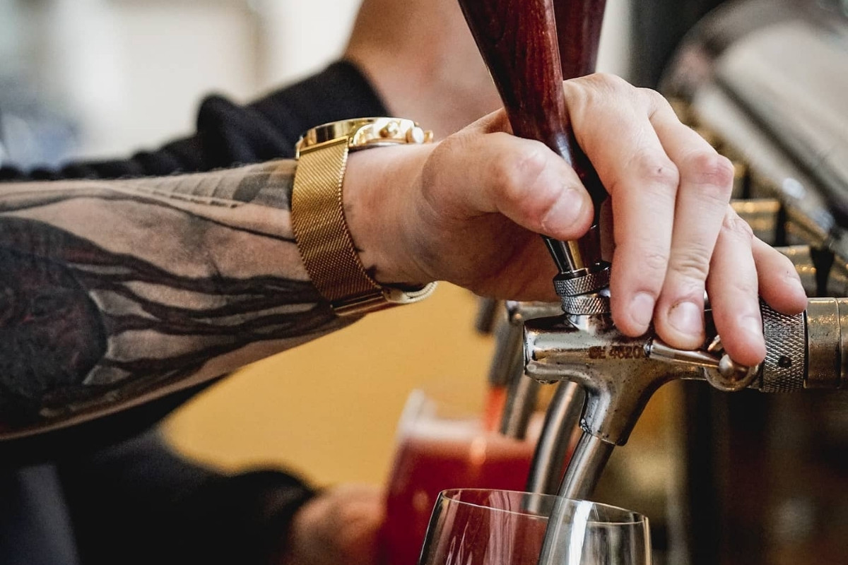 Fresh local beer from a tap at a Húsavík öl brewery.