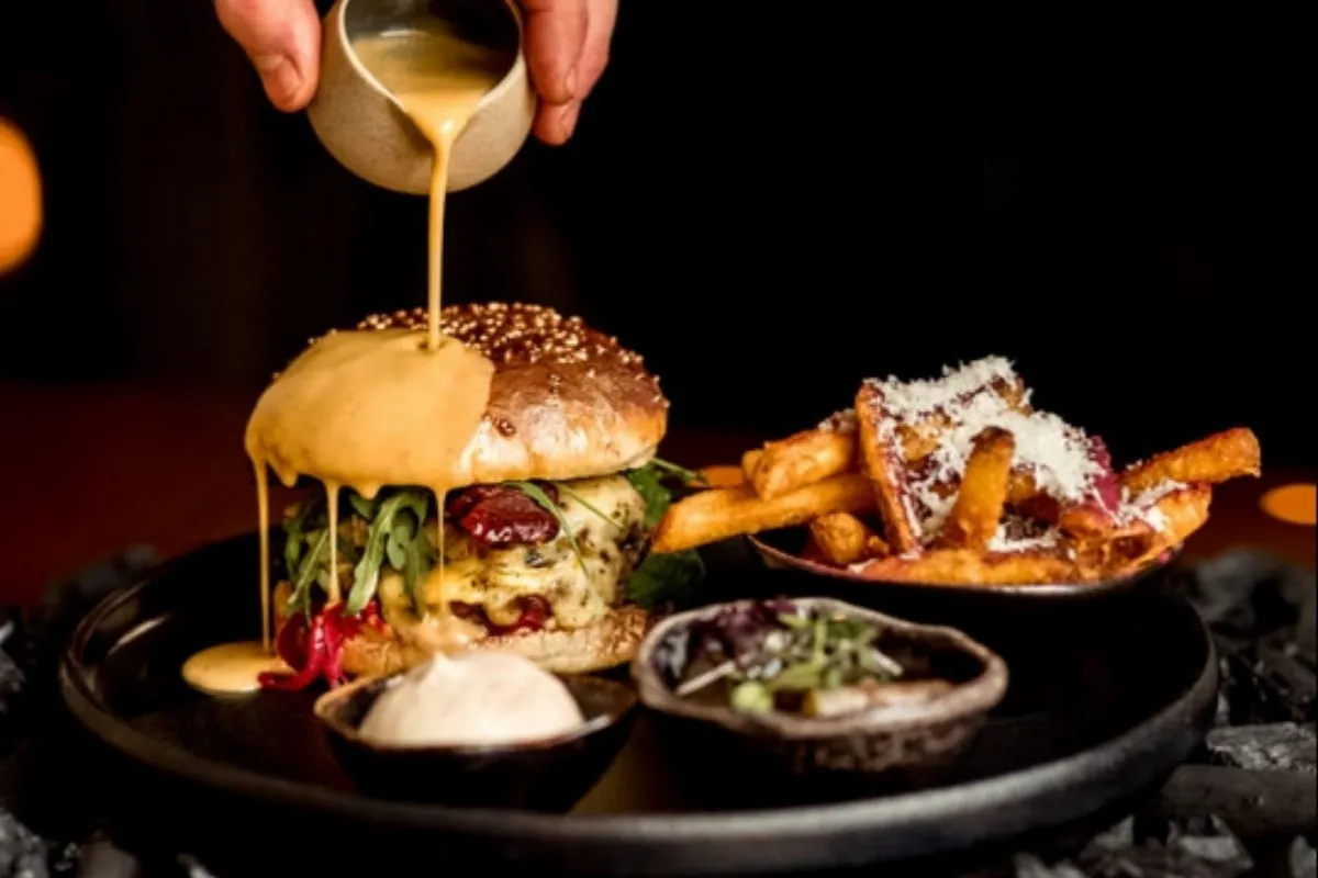 Signature KOL steak burger with truffle fries at KOL Restaurant, a top-rated fusion restaurant in downtown Reykjavik.