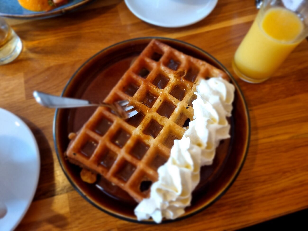 Crisp-edged waffle with cream at Berlin Cafe in Akureyri.