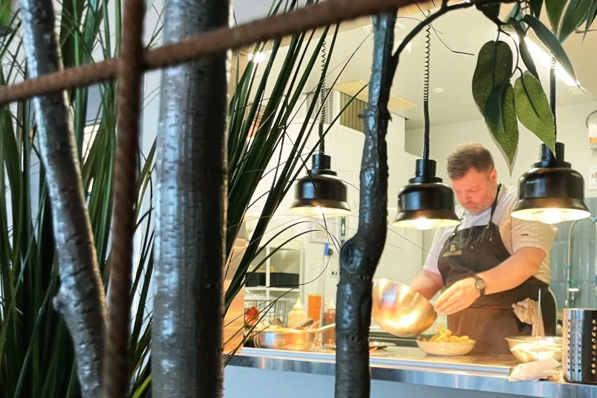 Professional chef and an open kitchen concept at Brasserie Kársnes restaurant in Reykjavik.