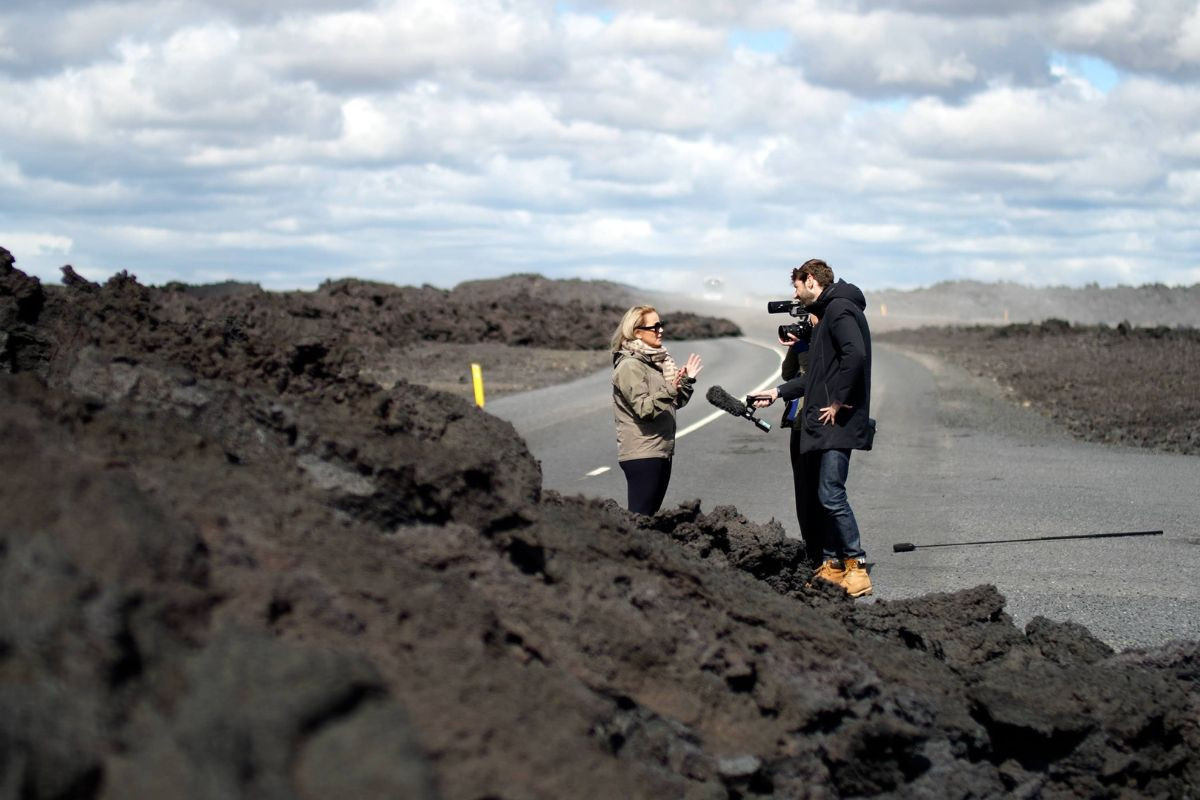 Guide speaking with a visitor among the lava fields near Grindavík, South Iceland