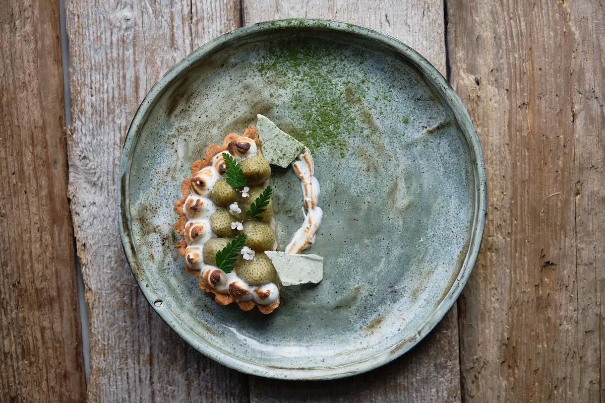 Plated fruit tart on a ceramic dish served at Eyja Wine Bar & Bistro in Akureyri.