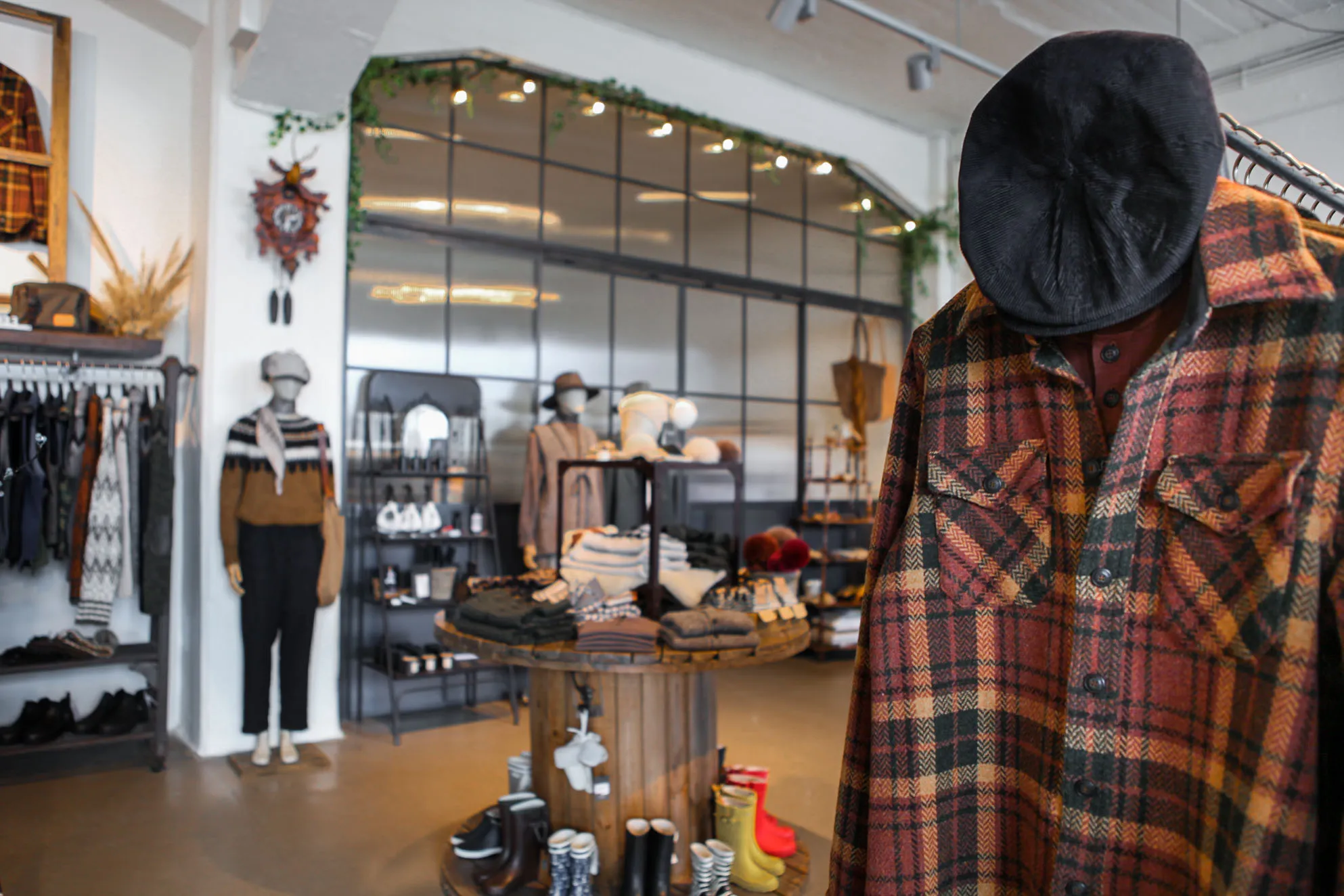 Interior of Farmers & Friends store in Hólmaslóð, Reykjavik with flannel shirts, lopapeysa sweaters, and outdoor boots.