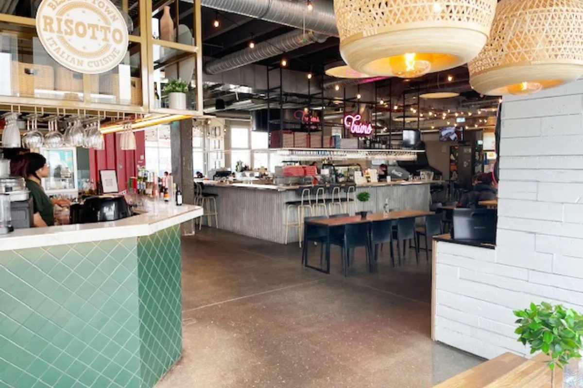 Wide shot of food stalls and diners inside Grandi Foodhall in Reykjavík.