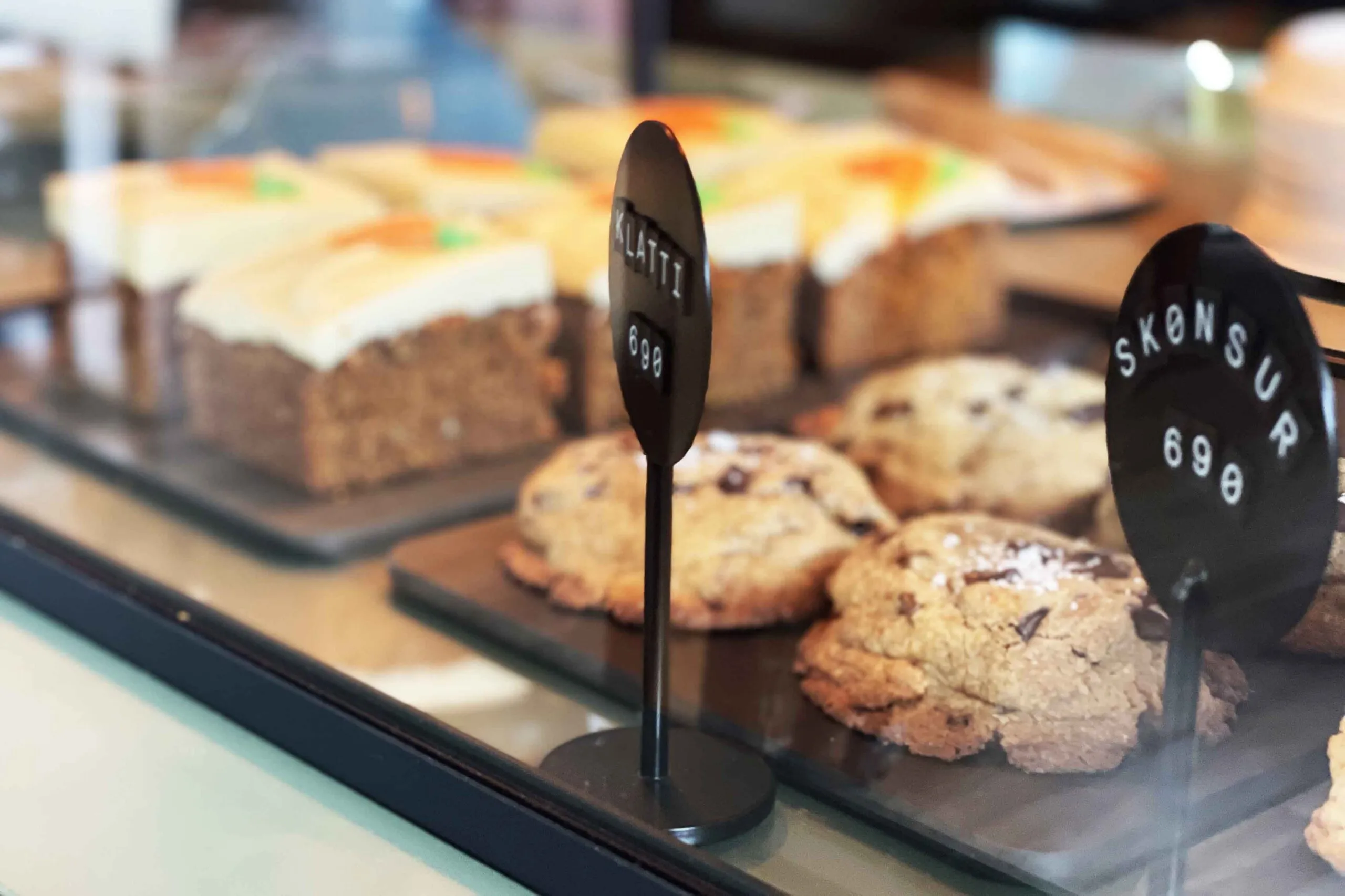 Fresh chocolate chip cookies and frosted carrot cake on display at Café Kokka in Reykjavik.