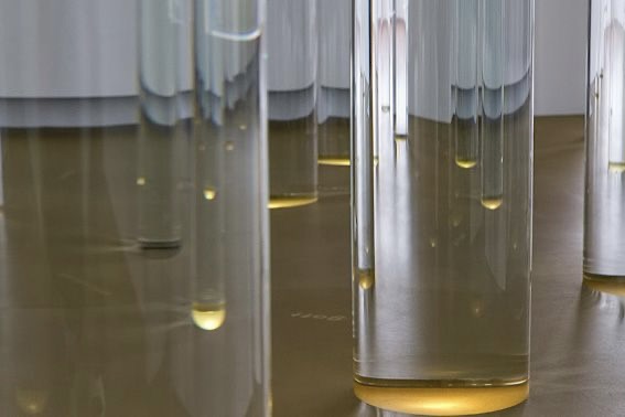 Transparent glass columns filled with water at the Library of Water in Stykkishólmur.