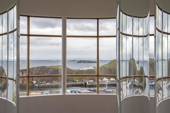 A panoramic view of the Stykkishólmur coast seen through the Library of Water in West Iceland, recommended by Handpicked Iceland.