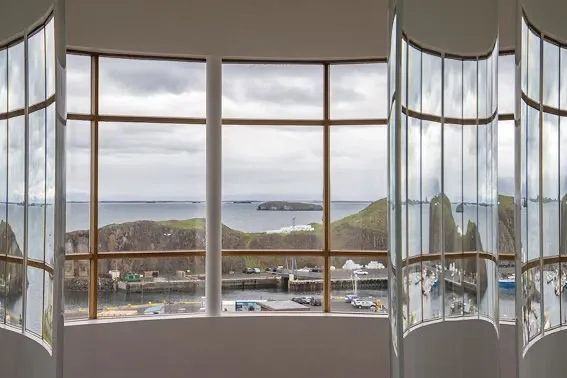 A panoramic view of the Stykkishólmur coast seen through the Library of Water in West Iceland, recommended by Handpicked Iceland.