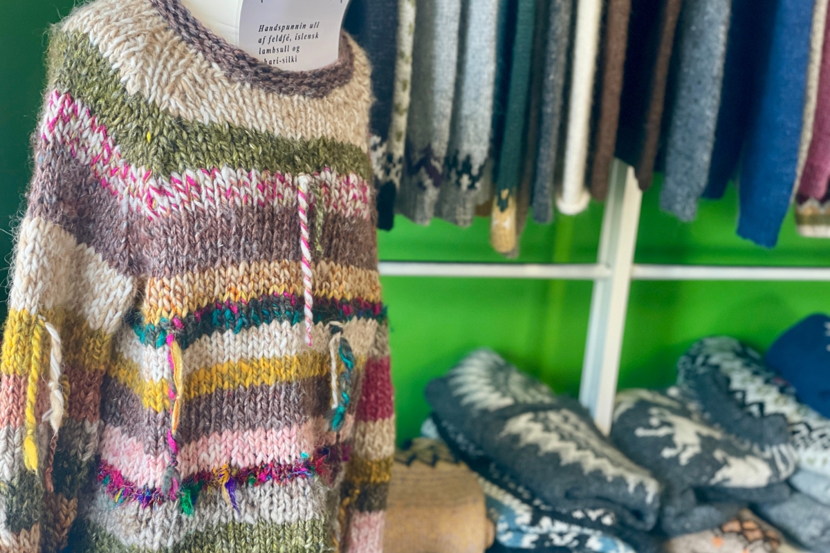 Multicolored hand-spun wool sweater displayed at Ljómalind Local Market.