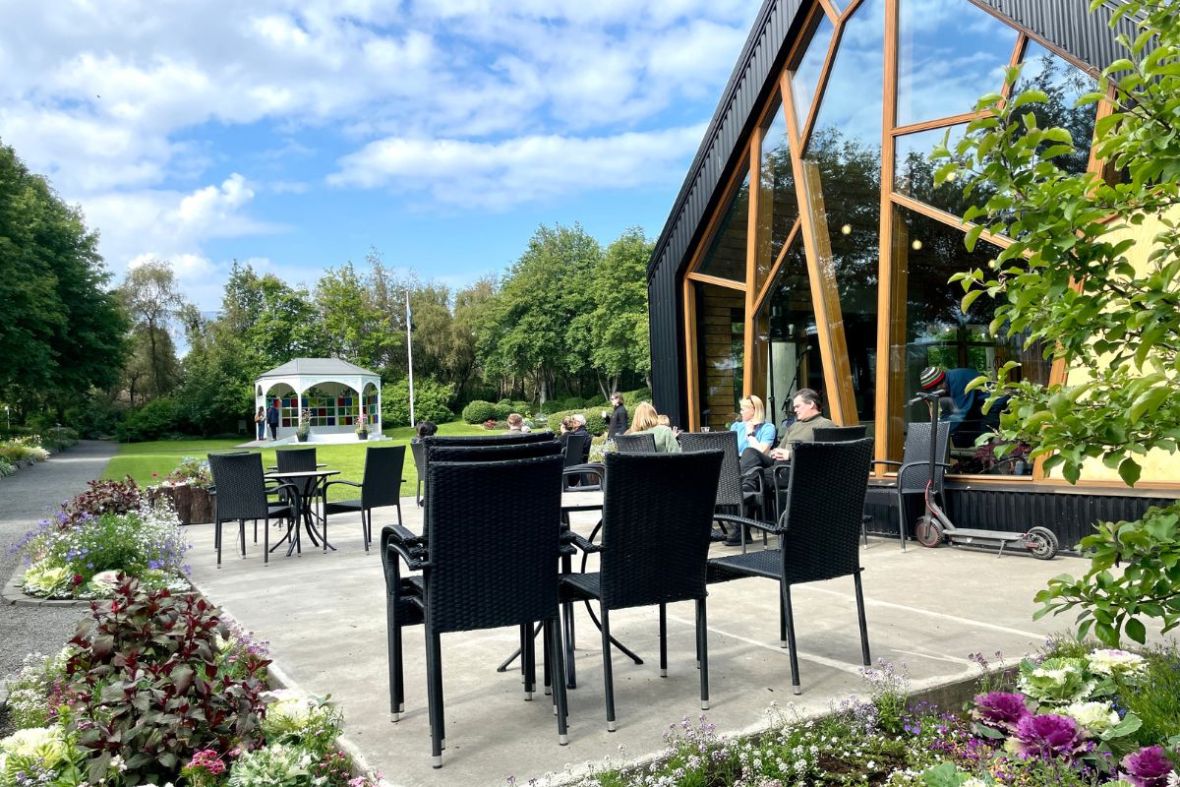 Outdoor terrace at LYST café in Akureyri Botanical Garden.