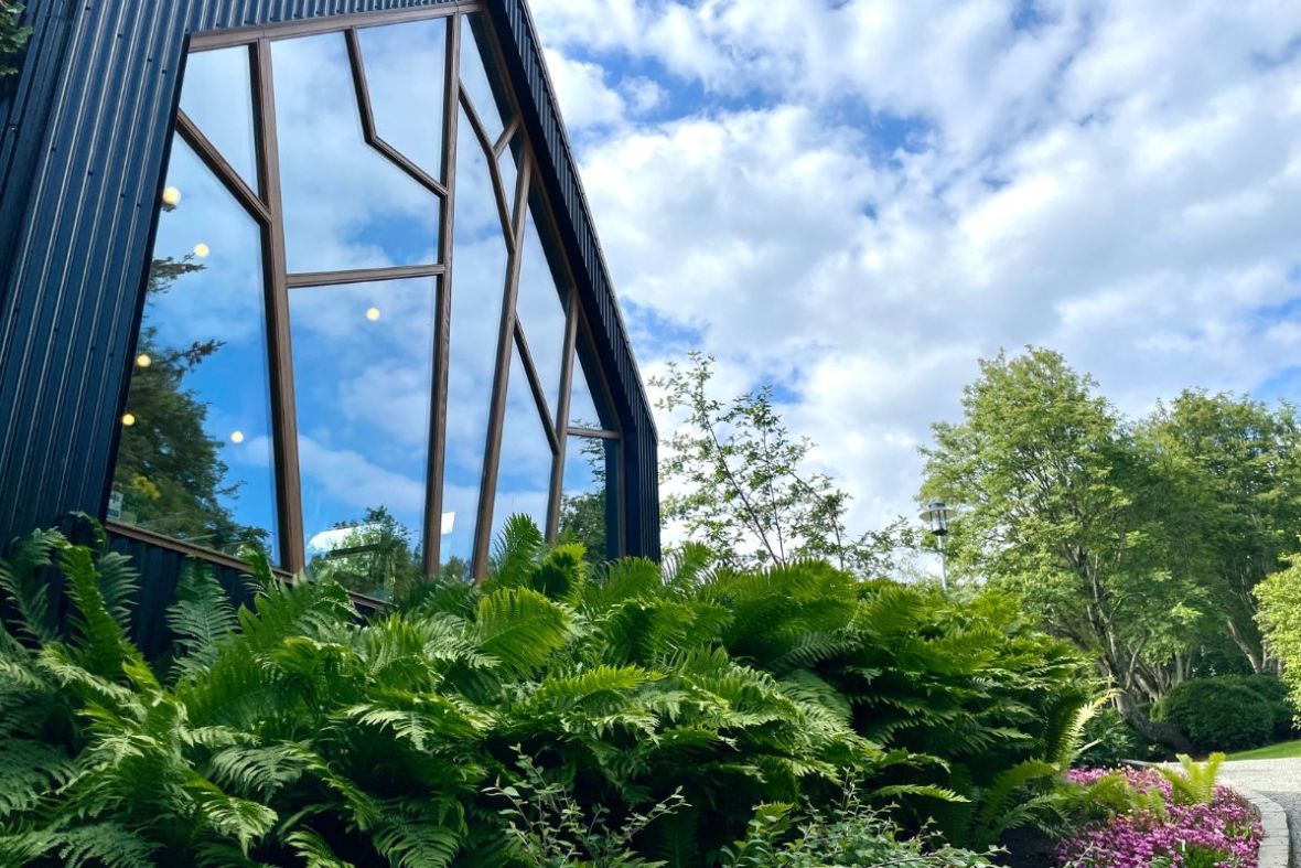 Modern exterior of LYST café surrounded by gardens in Akureyri, Iceland.
