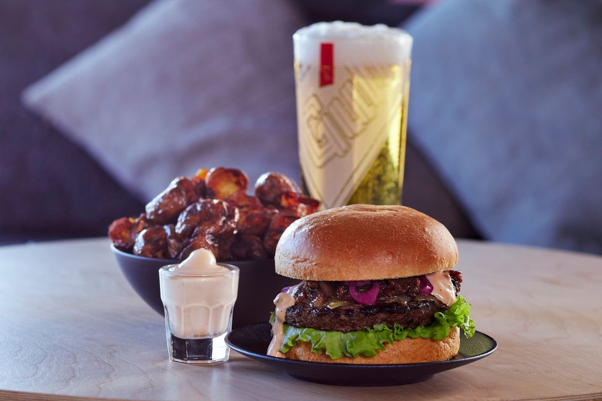 Burger, roasted potatoes, and beer at Midgard Restaurant, Hvolsvöllur.