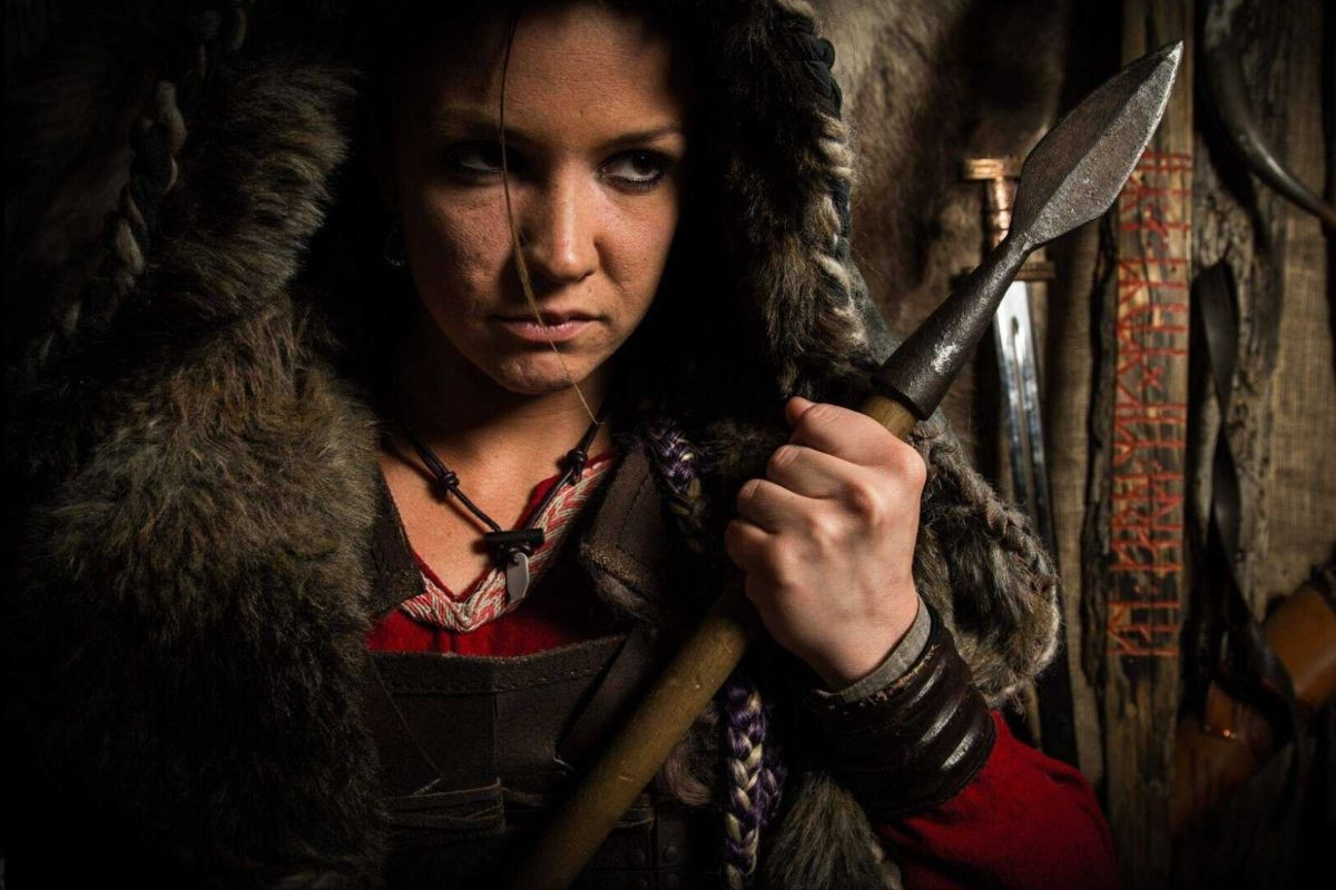 Close-up of woman in authentic Viking furs holding a spear at Mink Viking Portrait in Reykjavik.