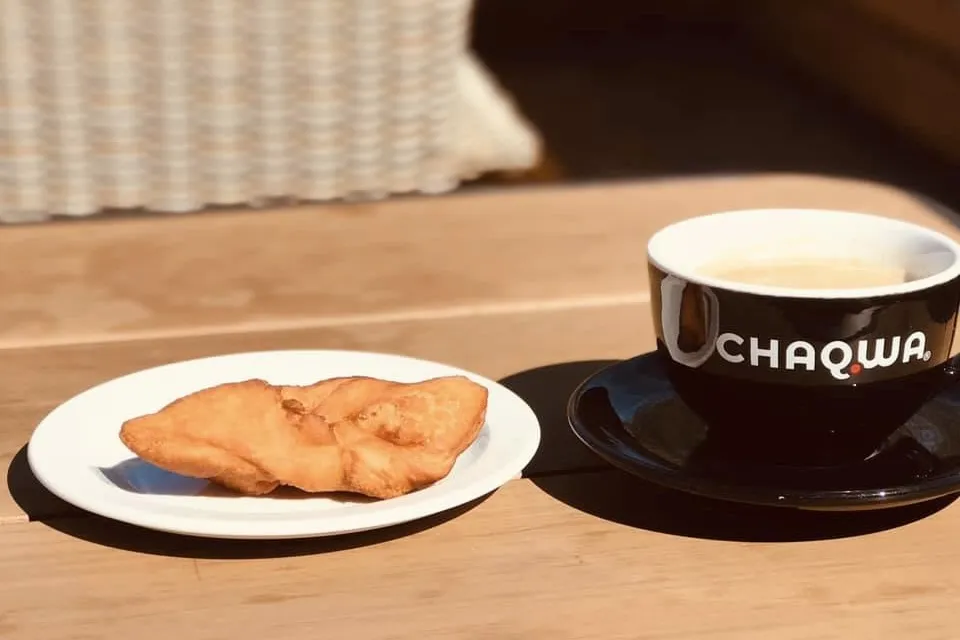 Chaqwa coffee and an Icelandic pastry on an outdoor terrace at Sesam Brauðhús Reyðarfjörður, East Iceland.