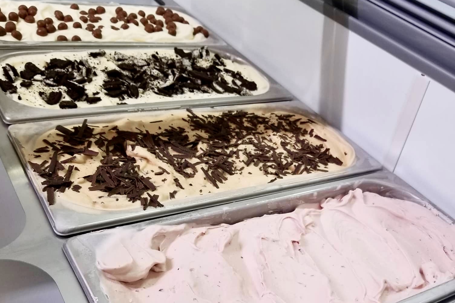 Ice cream display with multiple flavors at Skútaís Ice Cream.