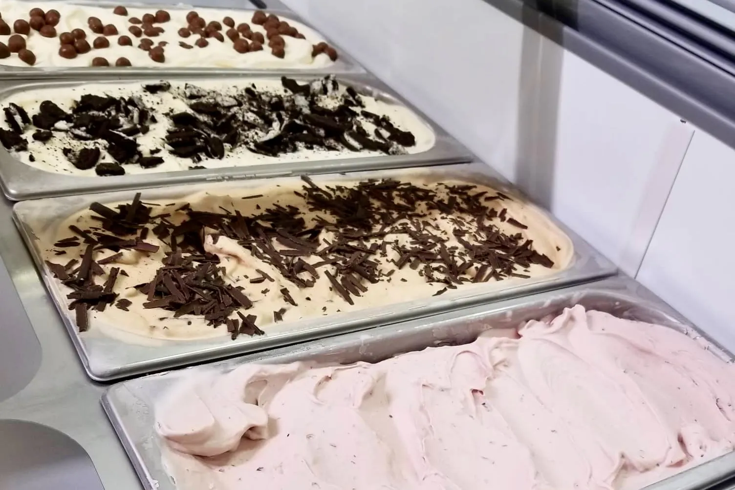 Ice cream display with multiple flavors at Skútaís Ice Cream.