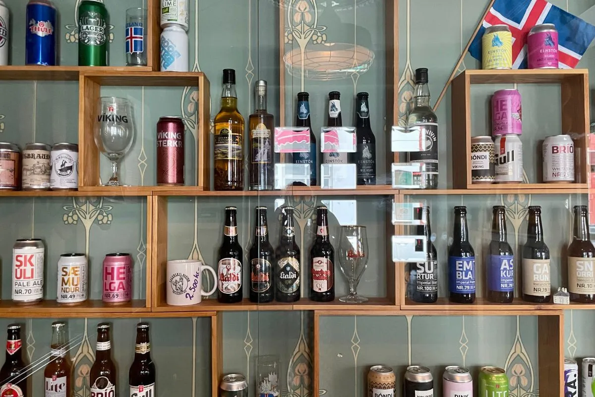 A wide selection of Icelandic craft beers and spirits on wooden display shelves at The Icelandic Bar in Reykjavik.