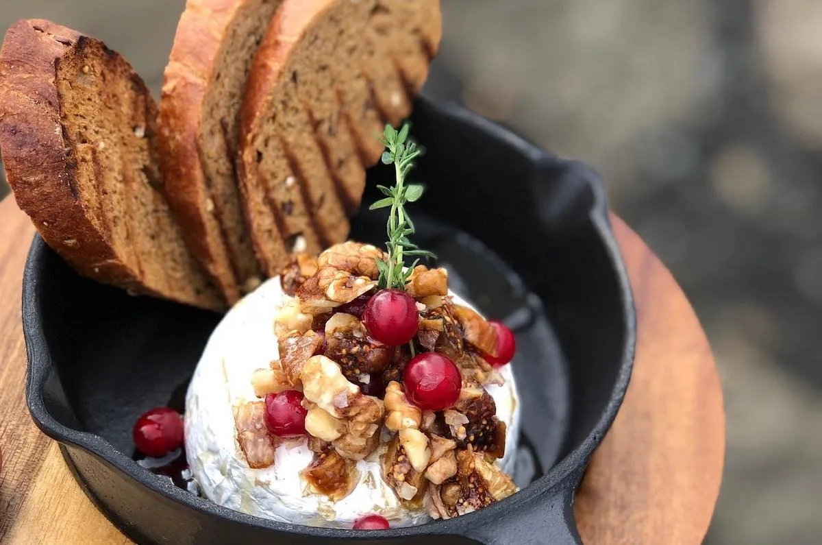 Rustic appetizer with cheese, fruit, and bread served at Vogafjós Farm Restaurant.