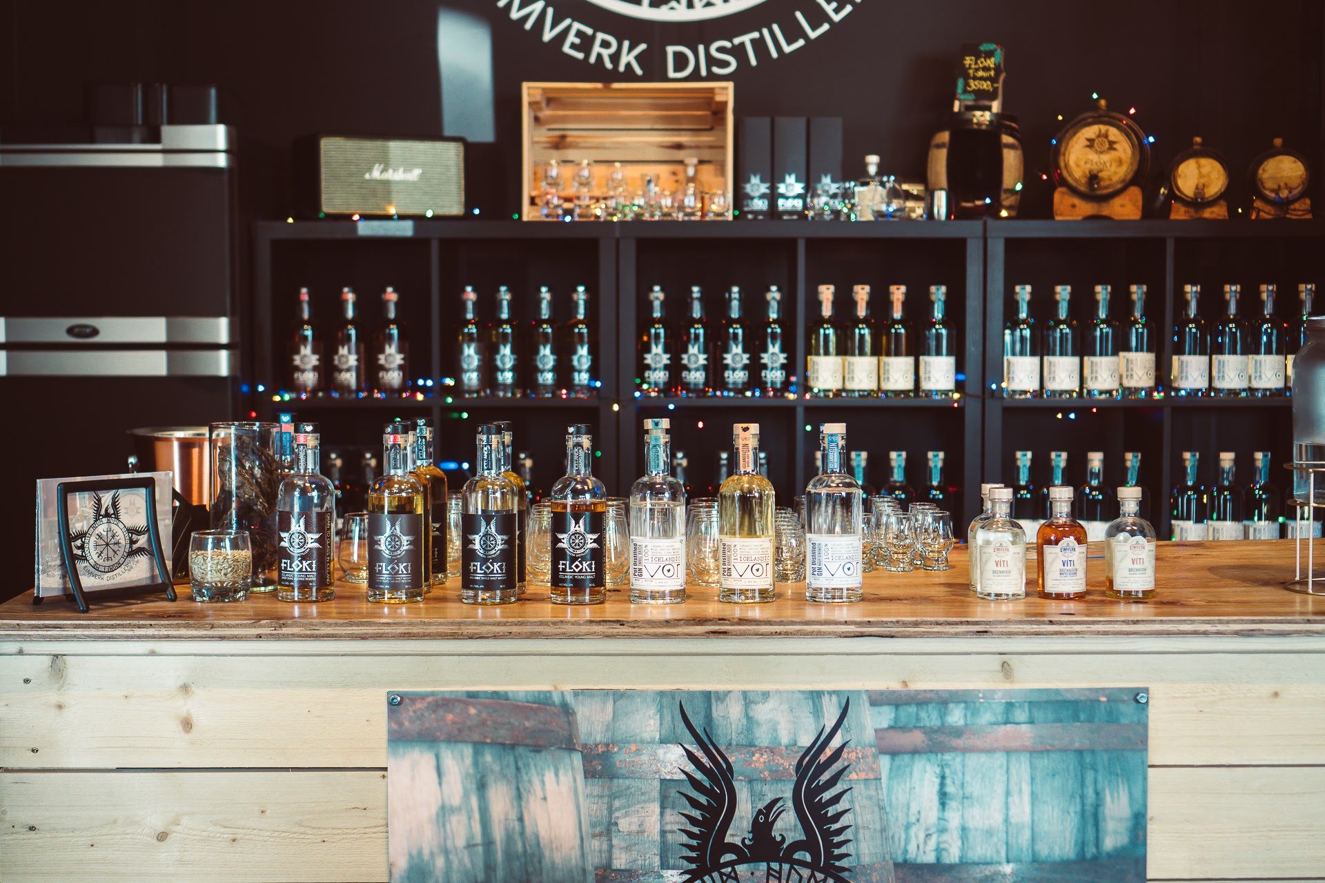 Eimverk Distillery tasting bar in Garðabær with Flóki whisky, Vor Gin, and Víti Brennivín on display.