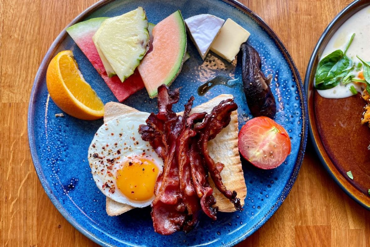 Traditional breakfast with egg, bacon, and fruit, Berlin Café, Akureyri, Iceland.