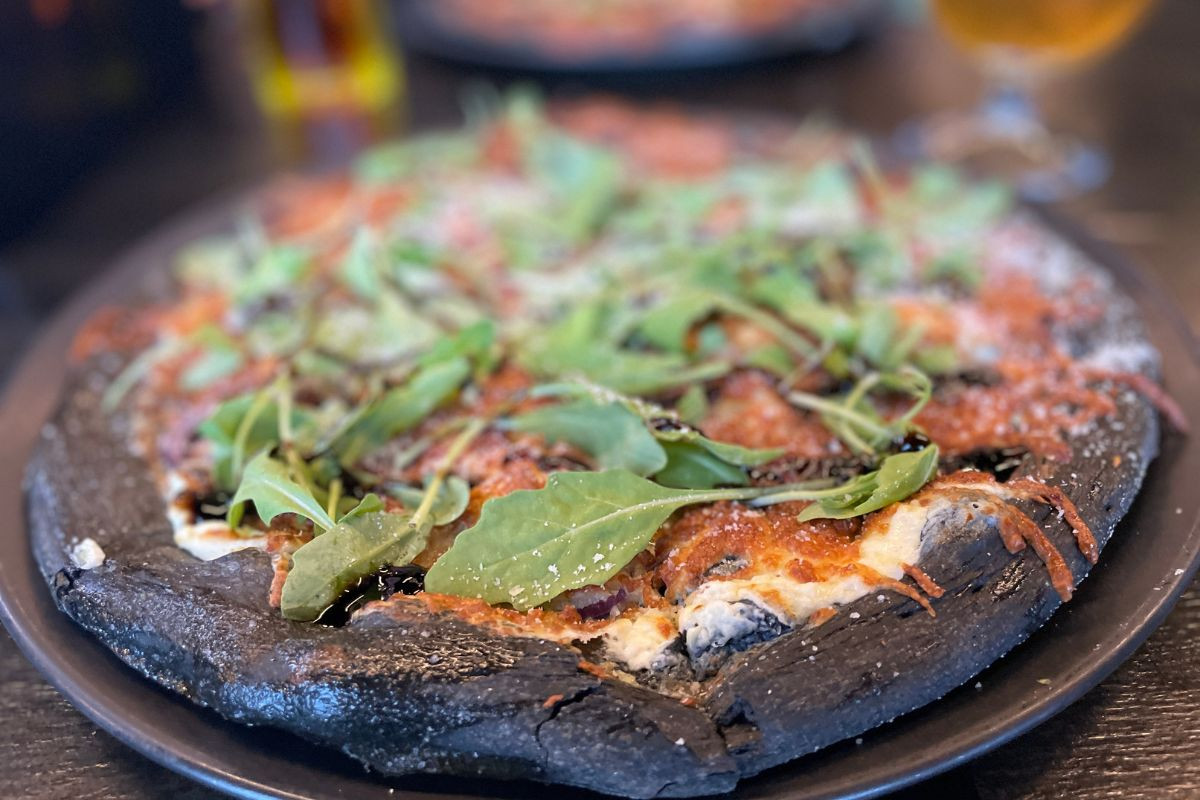 Black Crust black crust pizza with fresh toppings.
