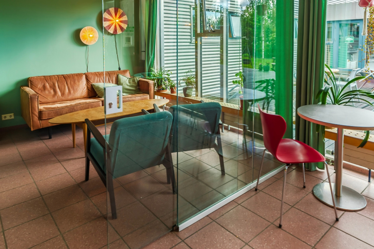 Lounge seating behind glass partition at Dalur Cafe in Reykjavik.