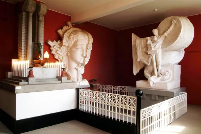 Large white plaster sculptures by Einar Jónsson displayed in a red-walled gallery at Einar Jónsson Museum.