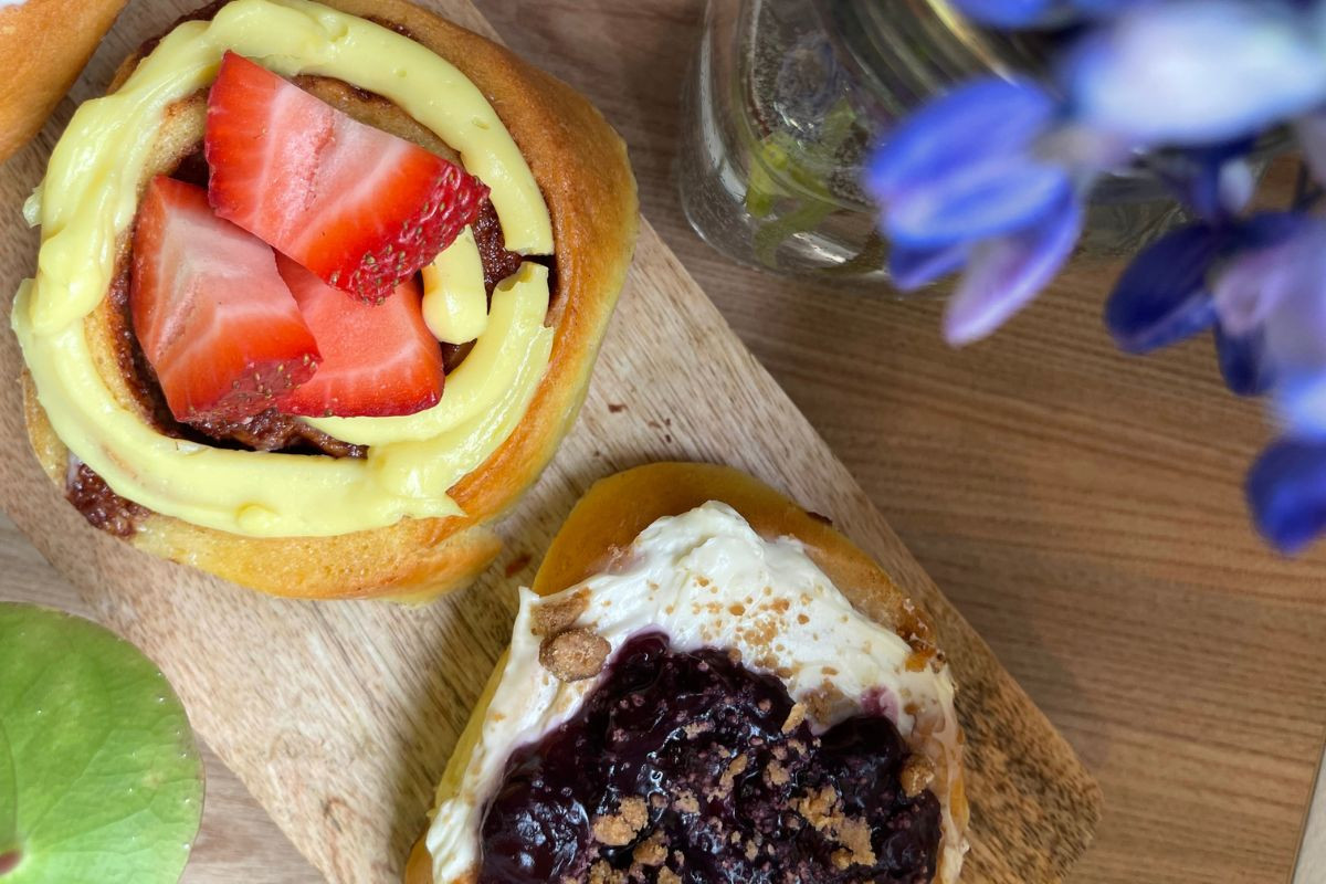 Fresh pastries topped with strawberries, cream, and jam at Faxi Bakery.