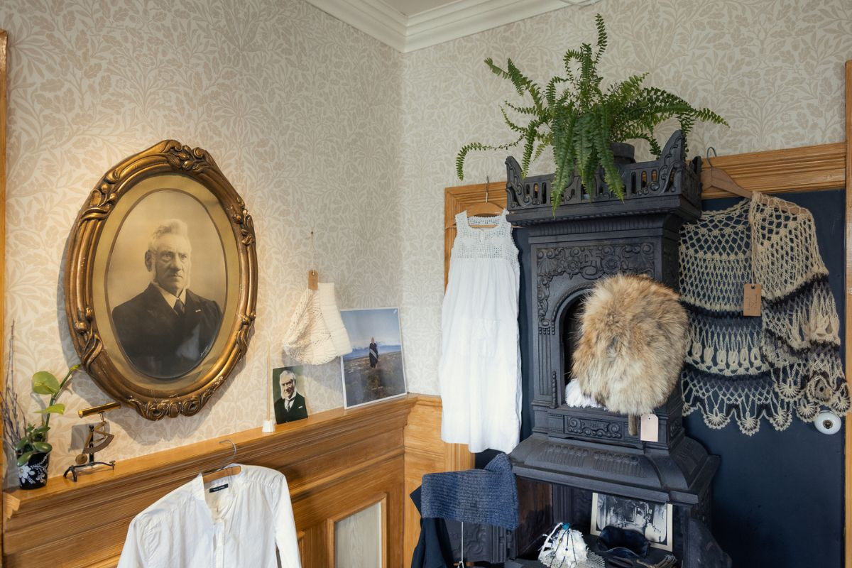 Traditional Icelandic clothing, knitwear, and historical portraits displayed inside Sigurhæðir culture house.