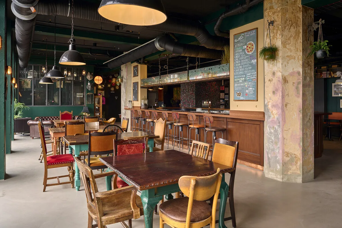 Dining area with wooden tables and pizza menu