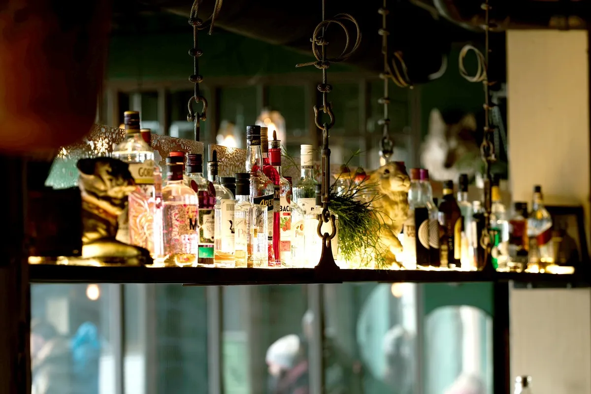 Shelf of spirit bottles hanging above the bar