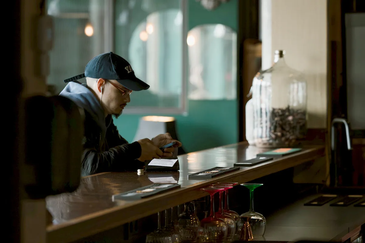 Guest sitting at the bar counter at KEX Bar in Reykjavík