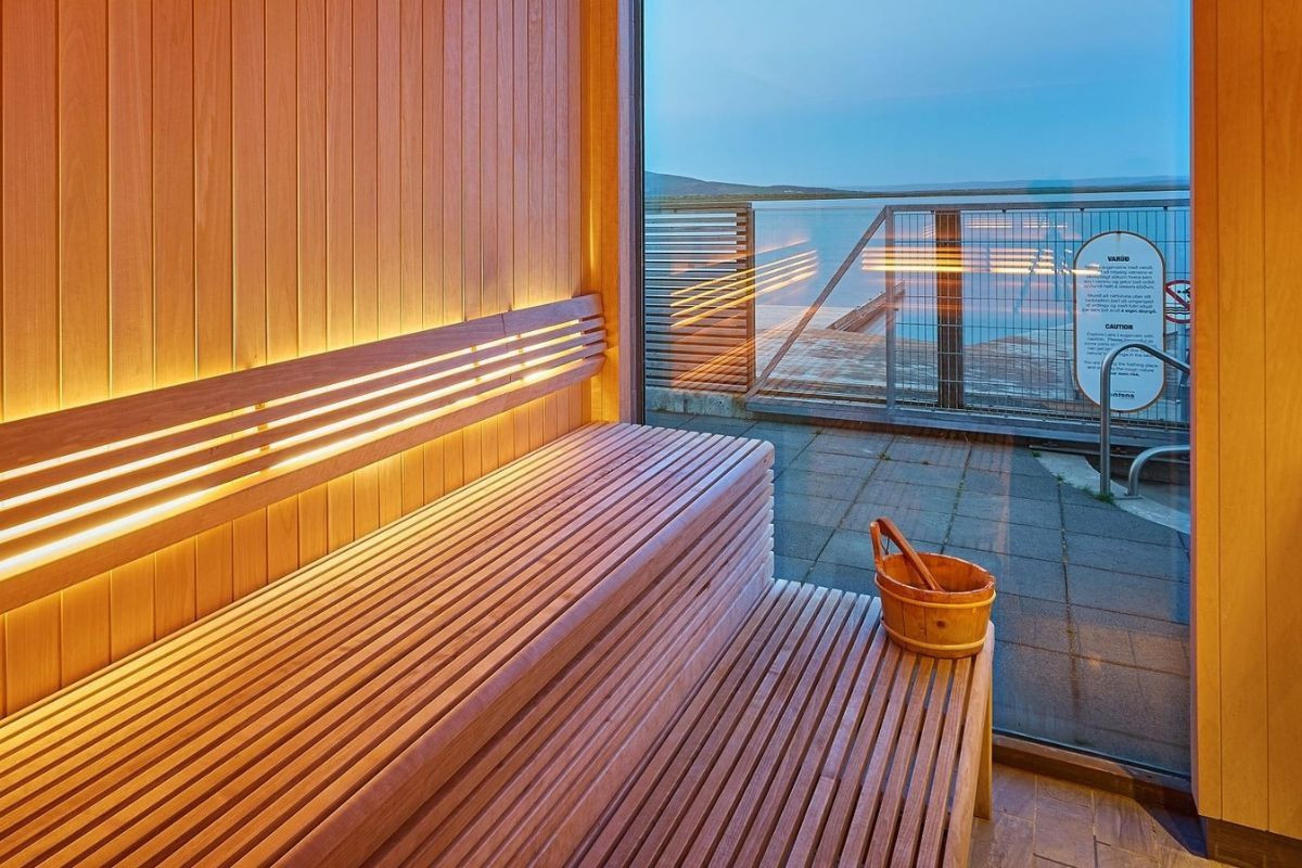 Wooden sauna interior with a large window overlooking the lake at Laugarvatn Fontana.