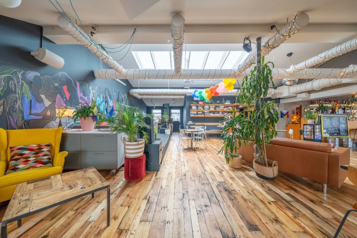 Loft Hostel Bar open lounge area with wooden floors and colorful seating in Reykjavik.