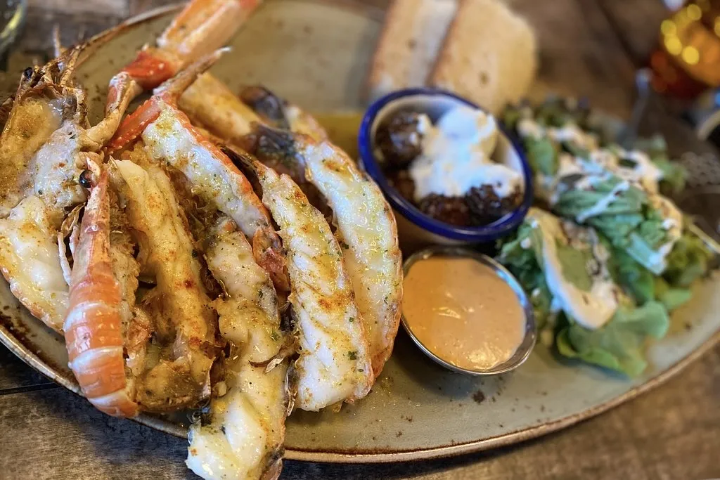 Fresh local langoustine platter at Pakkhúsið seafood restaurant in Höfn harbor, Iceland.