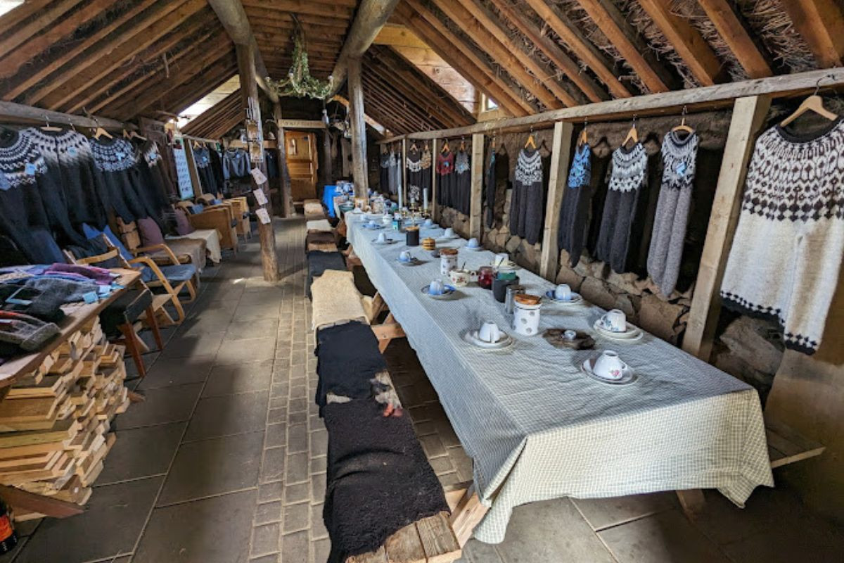 Sænautasel Turf Farmhouse interior with traditional Icelandic wool sweaters in Egilstaddir.