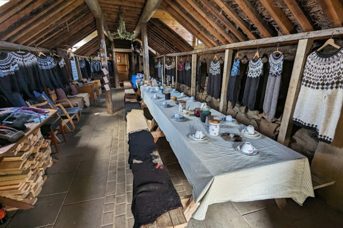 Sænautasel Turf Farmhouse interior with traditional Icelandic wool sweaters in Egilstaddir.