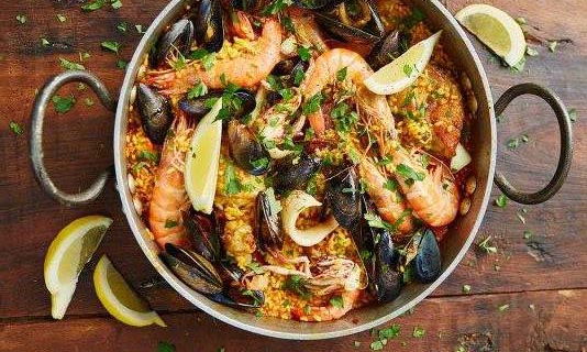 Fresh seafood paella with mussels, shrimp, and lemon at a Salt Eldhús cooking class in Reykjavik.