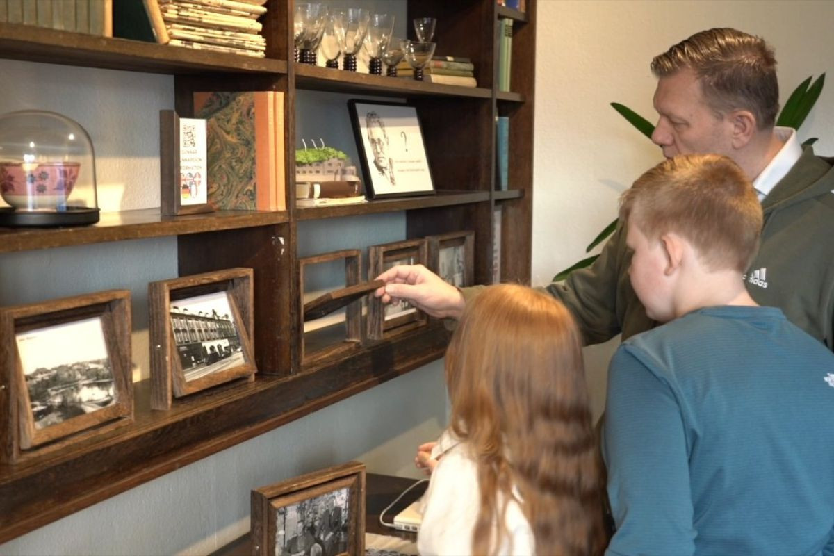 Family exploring archive displays at Skriðuklaustur History Center.