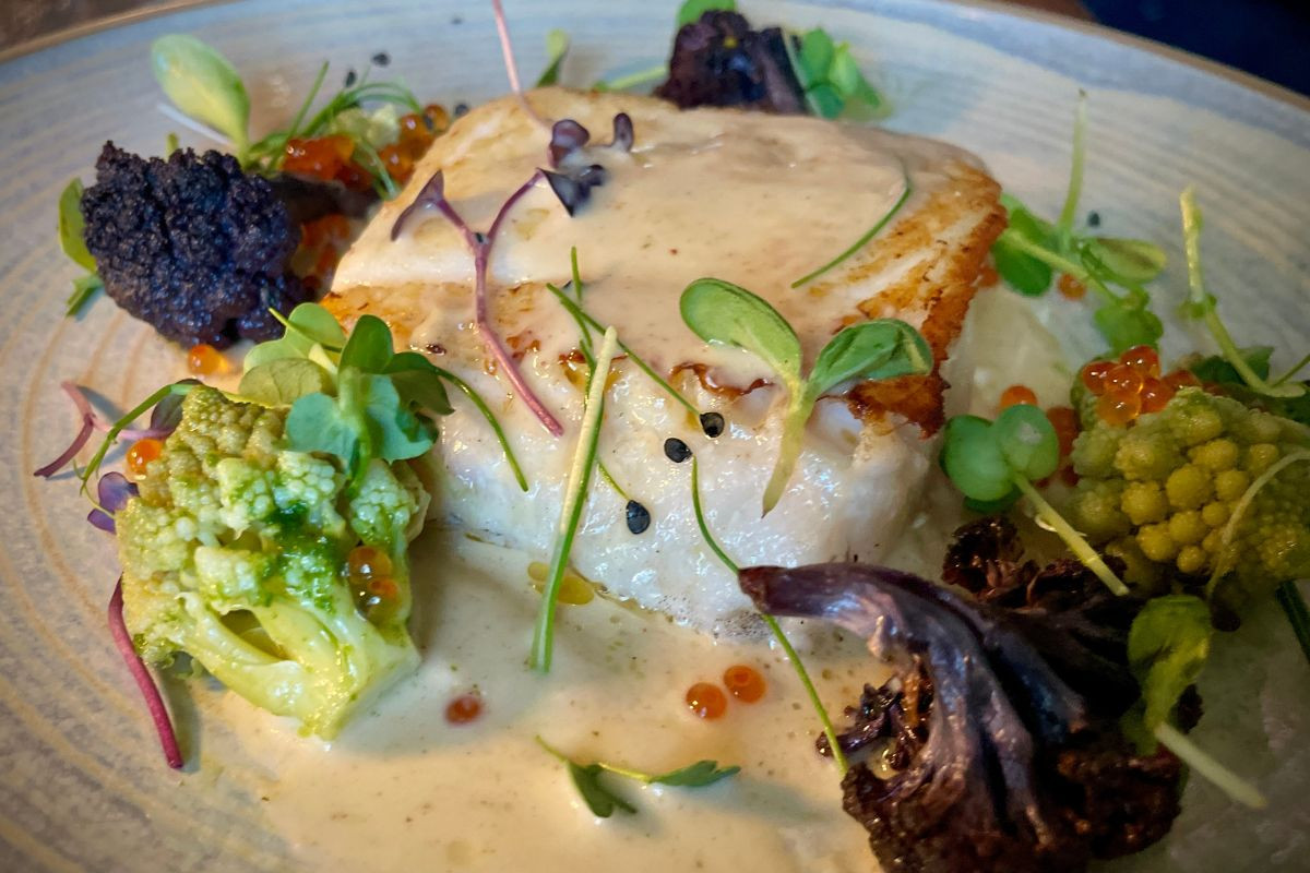 Pan-seared white fish with Romanesco, purple cauliflower, and roe at Tryggvaskáli Restaurant, Selfoss.