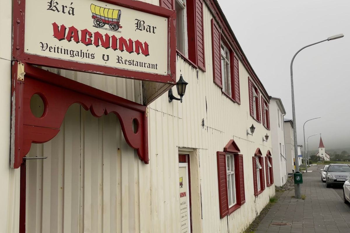 The white wood exterior of Vagninn restaurant and bar in Flateyri.