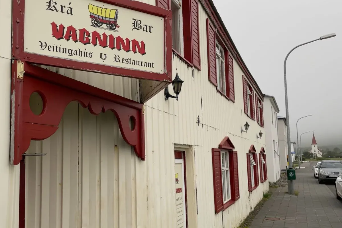 The white wood exterior of Vagninn restaurant and bar in Flateyri.